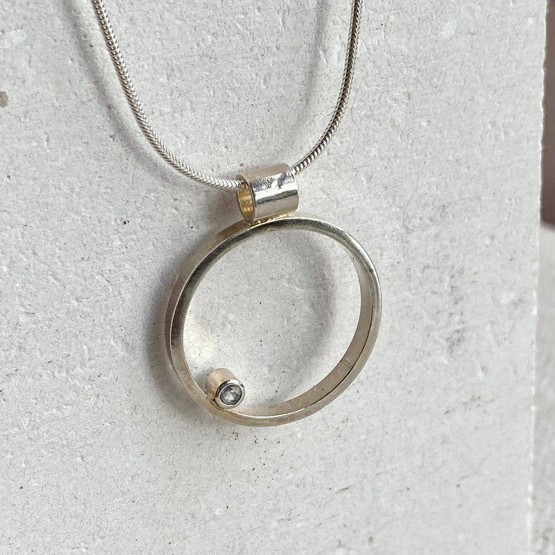 Silver Circle And Topaz Pendant